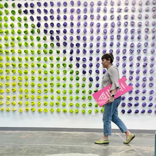 lisa solomon walking in front of an installation