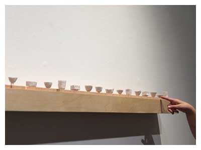 lisa solomon Chawan with Chataku - 25 camps / 25 tea bowls, 2019, paper pulp, gold pen, wooden coasters,  shelf, 5.5 x 76 inches